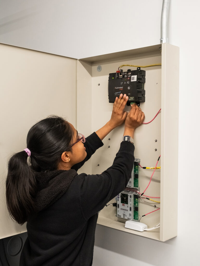Student wiring a piece of equipment