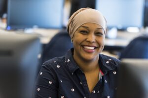 Female student smiling in a computer lab