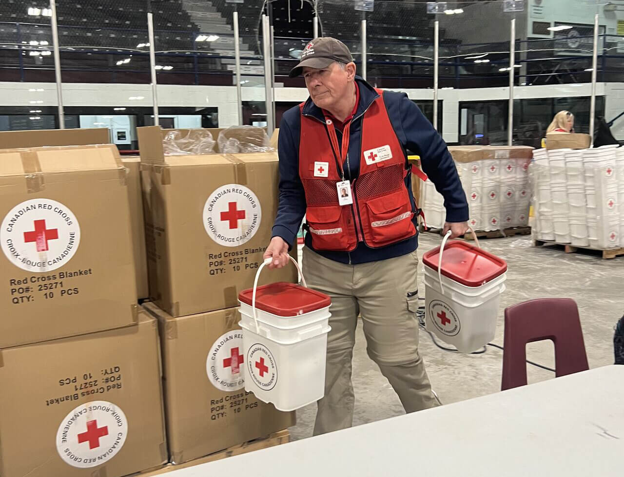 Guy Lepage carries buckets during relief operations in Manitoba.