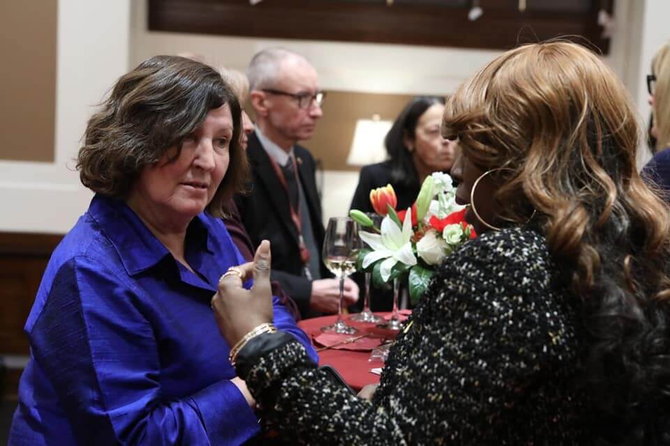 Sophia Jacob and Senator Mary Coyle talk at a table.