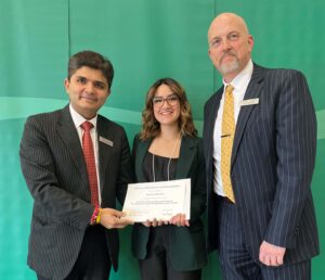 Karina Cifuentes posing with their award