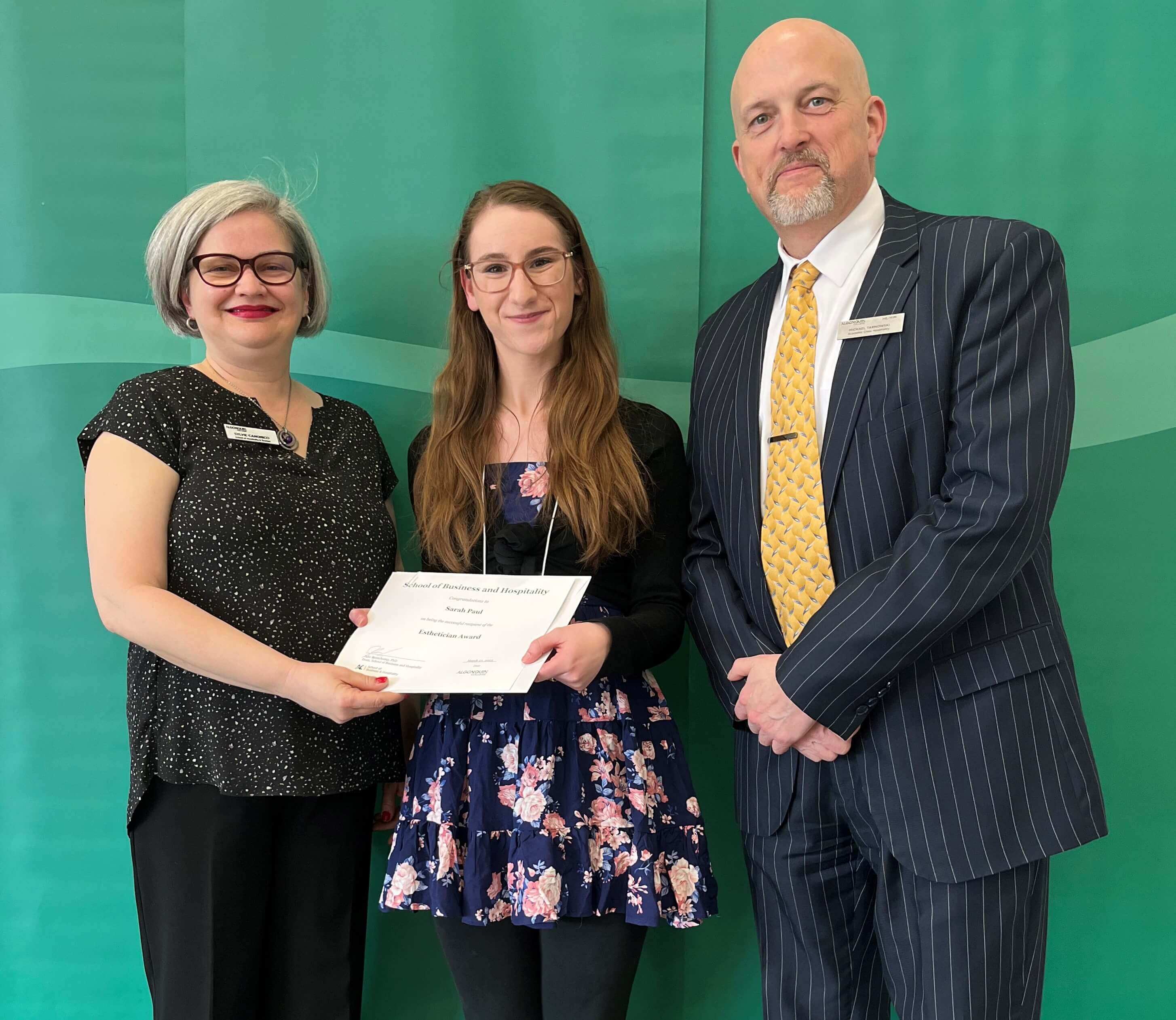 Student Sarah Paul, Recipient of the Esthetician Award, with professors