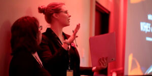 Events management students discussing plans backstage