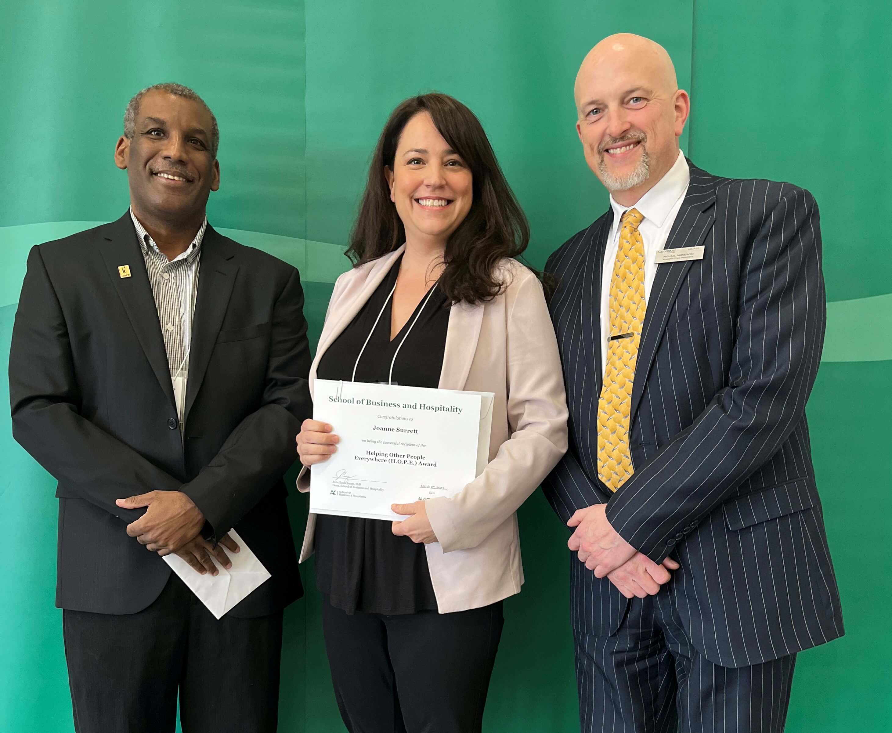 Student Joanne Surette, Recipient of the Helping Other People Everywhere Award, with professors