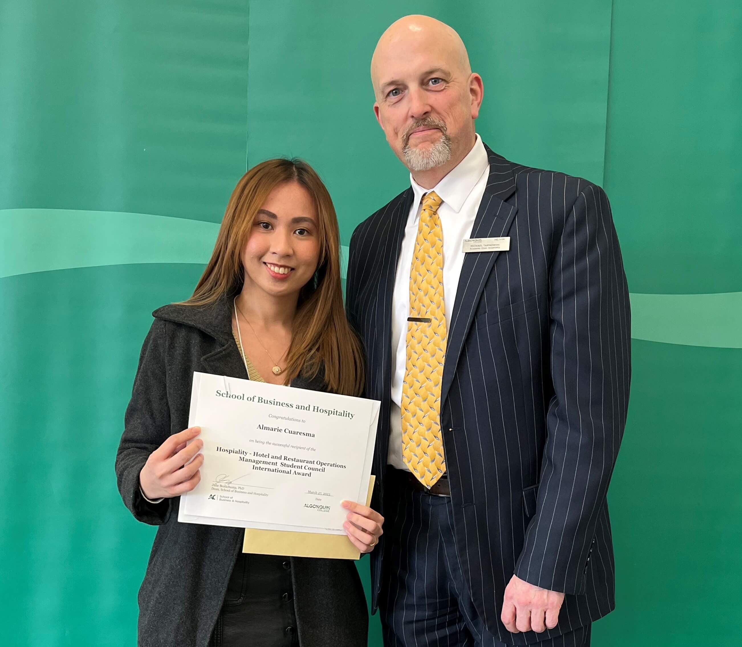 Student Almarie Cuaresma, Recipient of the Hospitality - Hotel & Restaurant Operations Management Student Council International Award, with professor
