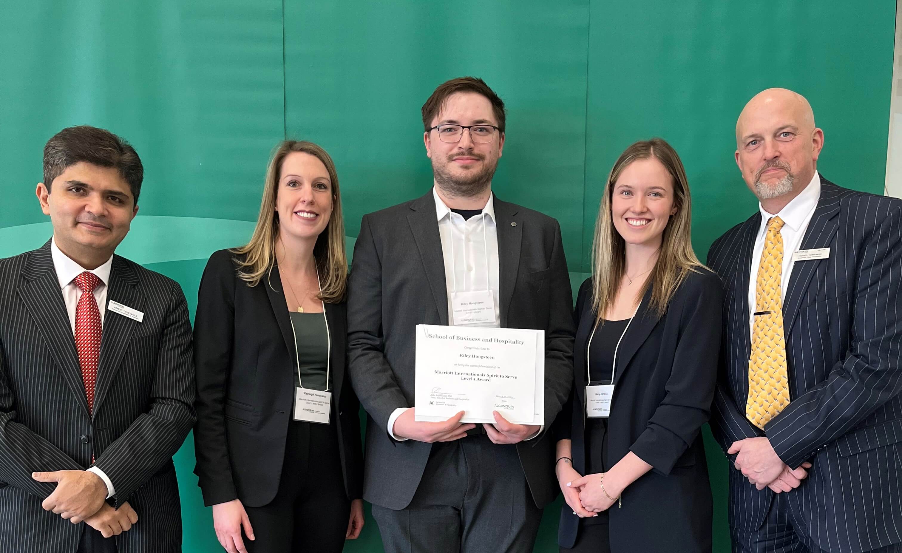 Student Riley Hoogsteen, Recipient of the Marriott International Spirt to Serve Level 1 Award, with professors