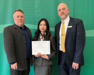 Anh Bui posing with their award