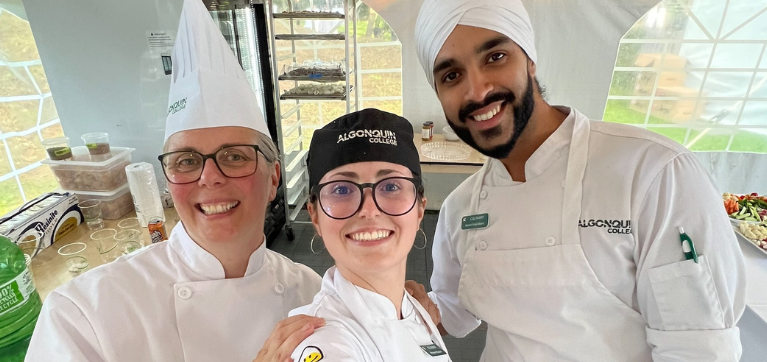 Culinary instructor poses with students