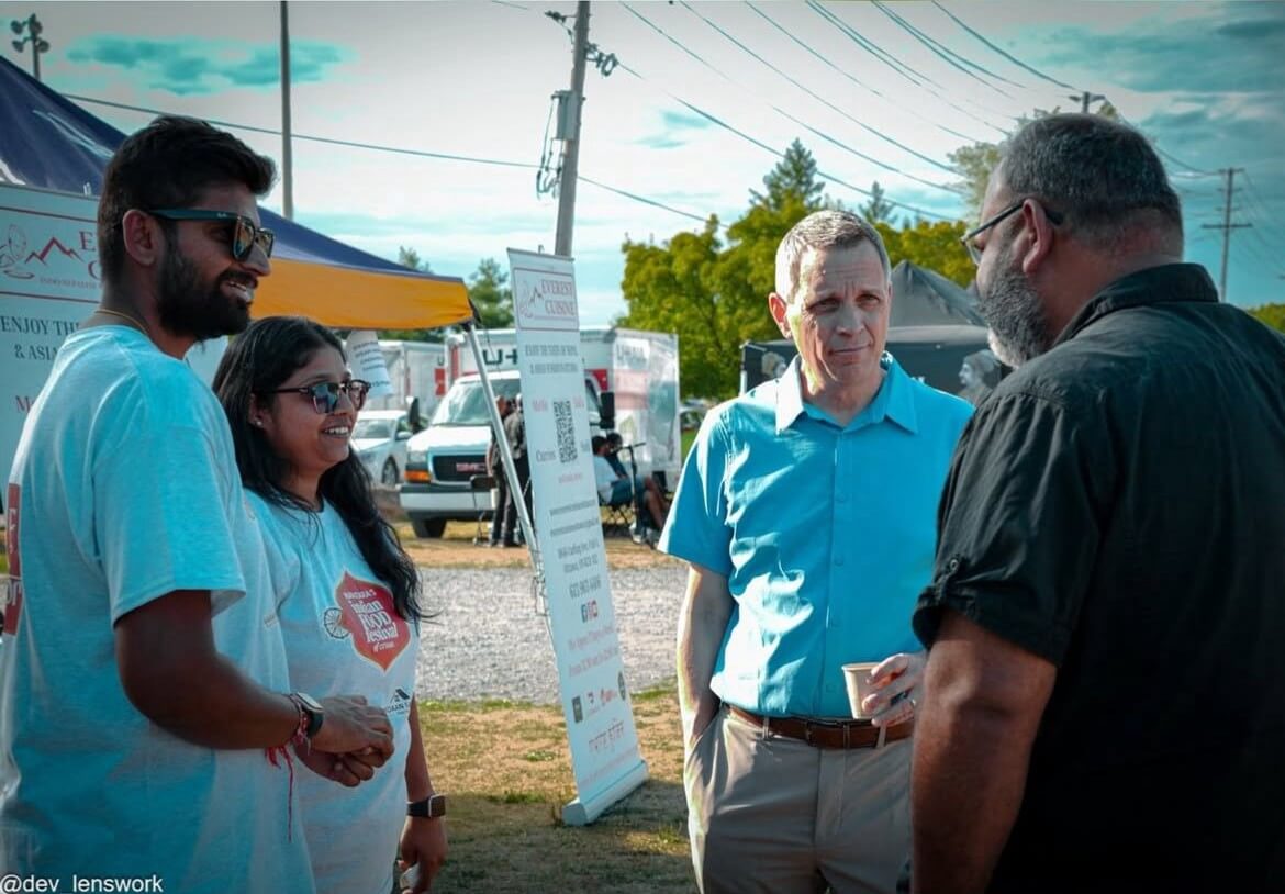 Small group of people chatting at food festival