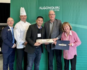 Male student being given award by Canada Cutlery Inc