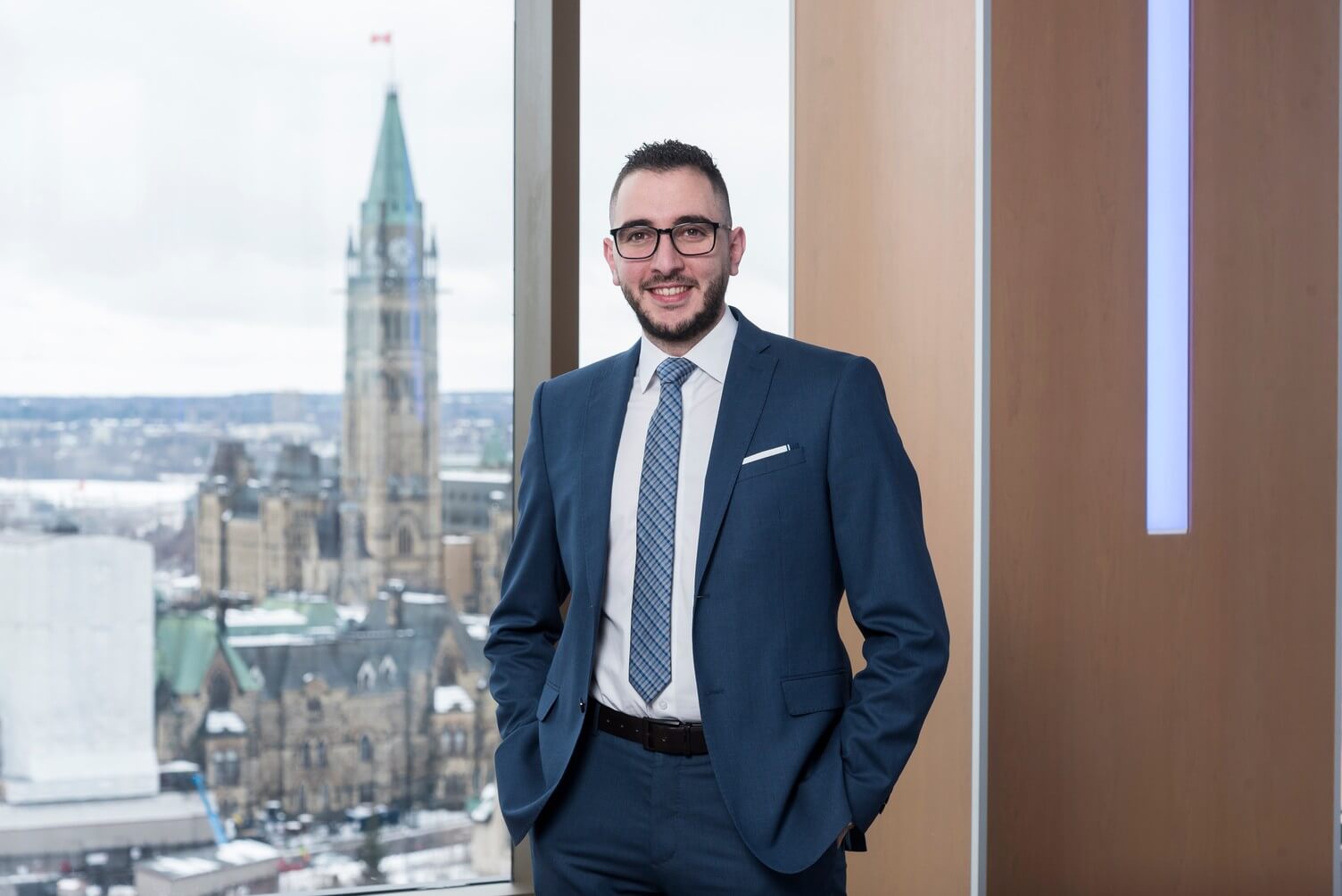 male business hospitality graduate in business suit with parliament in background