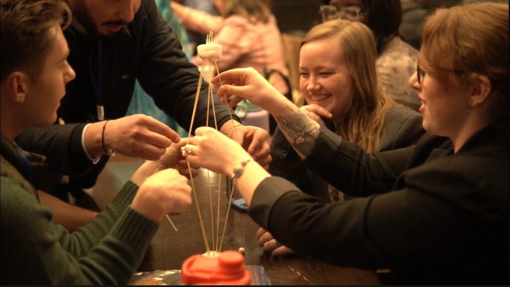 students working on team work at project management event