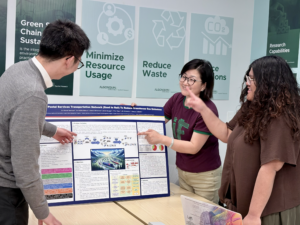 three students explaining sustainability project board