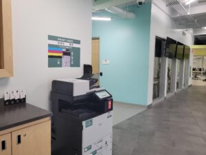 An image of a Ricoh multi function printer located on the first floor of C building near the elevator.