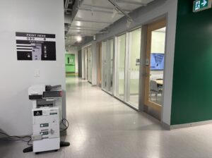 An image of a Ricoh multi function printer located on the second floor of C building, near room C264