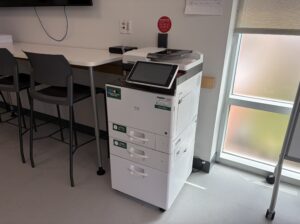 An image of a Ricoh multi function printer located on the first floor of V building
