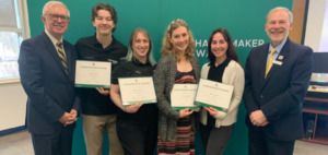 four students stand with Board Chair Jay MacLaren and Claude Brule at the April Board meeting