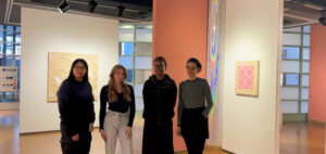 tudents Eleanor Liu, Kierstyn Auger, Treasure-Lee Ilunga, stand with Prof. Natasha Mazurka at her exhibit at Ottawa City Hall.