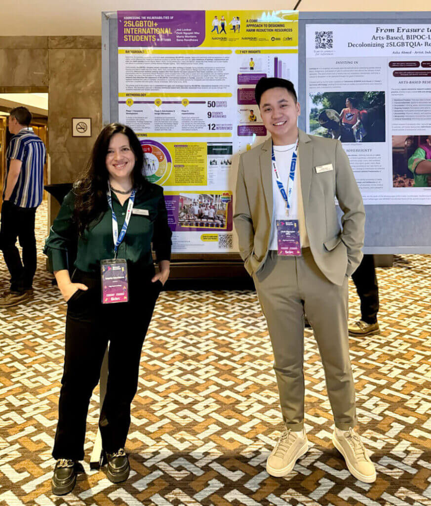 Two people stand in front of an informative poster at a conference
