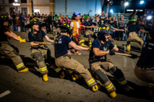 Algonquin College Pre-Service Firefighter Education and Training Students pulling a rope as part of the Ottawa Fire Truck Pull