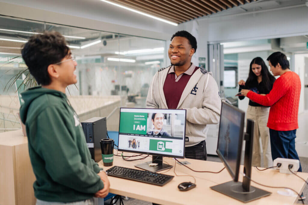 Student gets help from student support services at help desk.