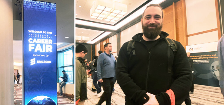 A person wearing a black jacket and backpack stands indoors at a professional networking event. Several people are in the background talking or checking their phones. The room is brightly lit with modern ceiling lights and wood paneling. A banner for ‘QUARRY Management Consulting and Customized Staffing Solutions’ is visible behind them.