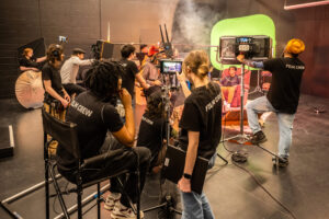 Student film crew preparing a shot with a variety of equipment