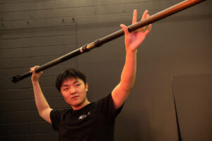 Student holding a boom mic pole