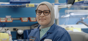 two women standing with coffee in hand
