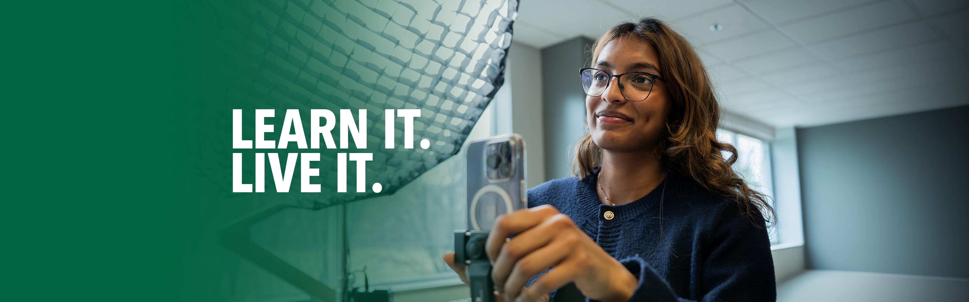Student using a smartphone mounted on a tripod to create digital content in a bright, modern learning space.