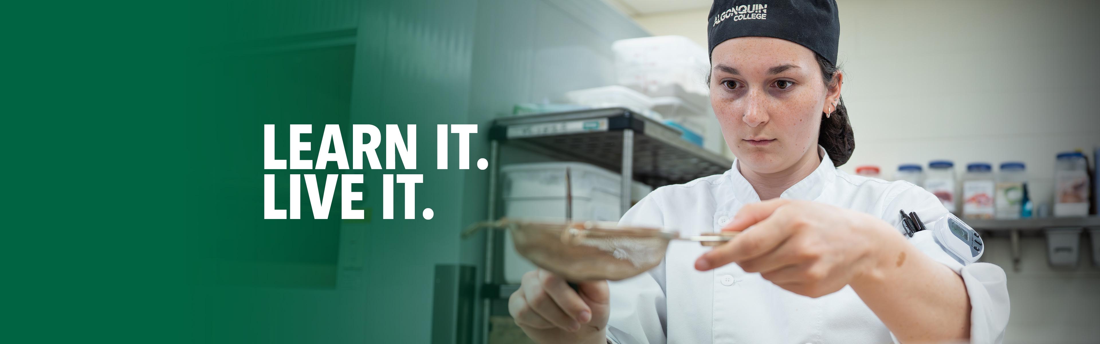 Culinary student in a chef uniform carefully sifting ingredients while working in a professional teaching kitchen.