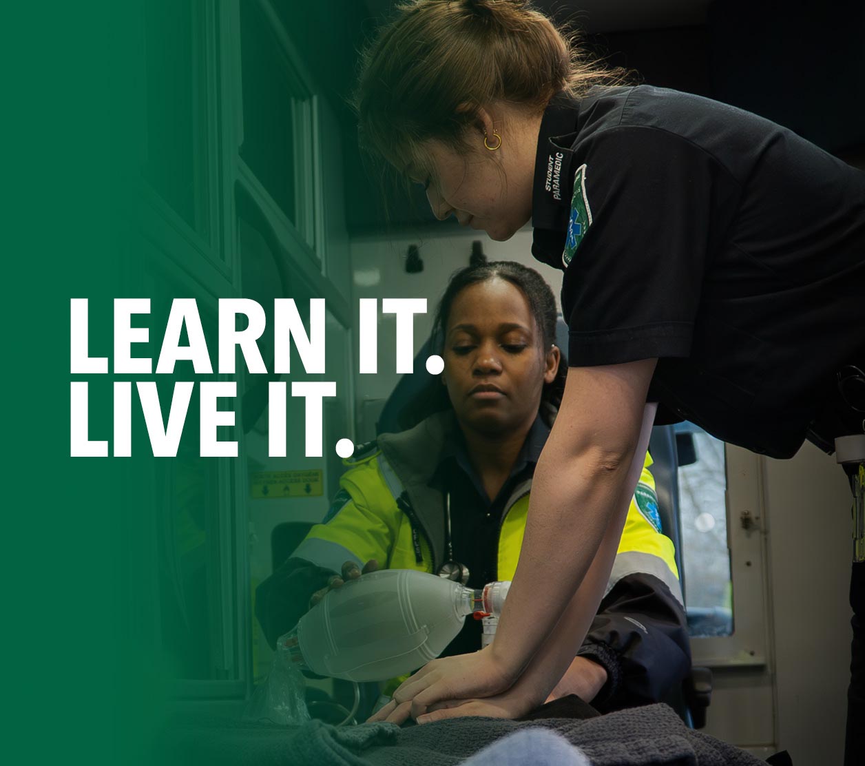Paramedic students practising emergency patient care with medical equipment inside an ambulance during hands-on training.