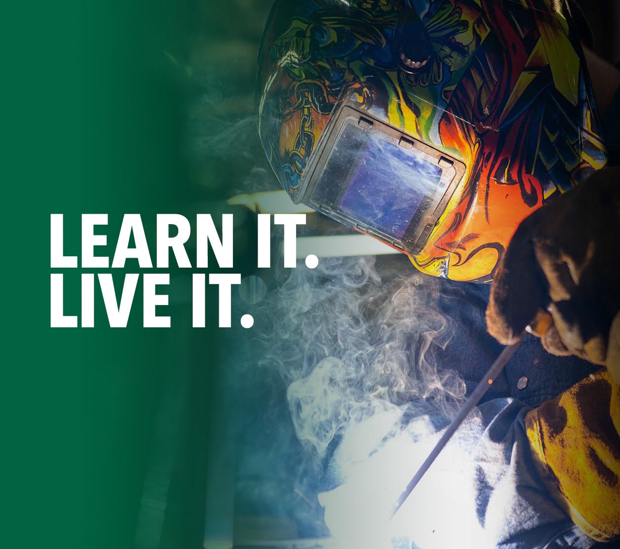 Welding student wearing protective equipment while welding metal during hands-on skilled trades training.