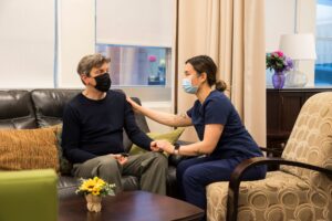 Personal Support Worker student working with a client in the smart apartment on campus