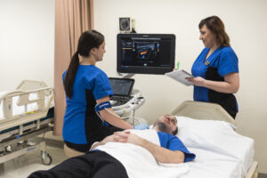 students practicing sonography techniques in the lab