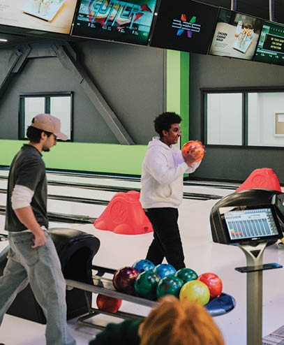 A group of people are playing a game of bowling in a bowling alley. AI generated content