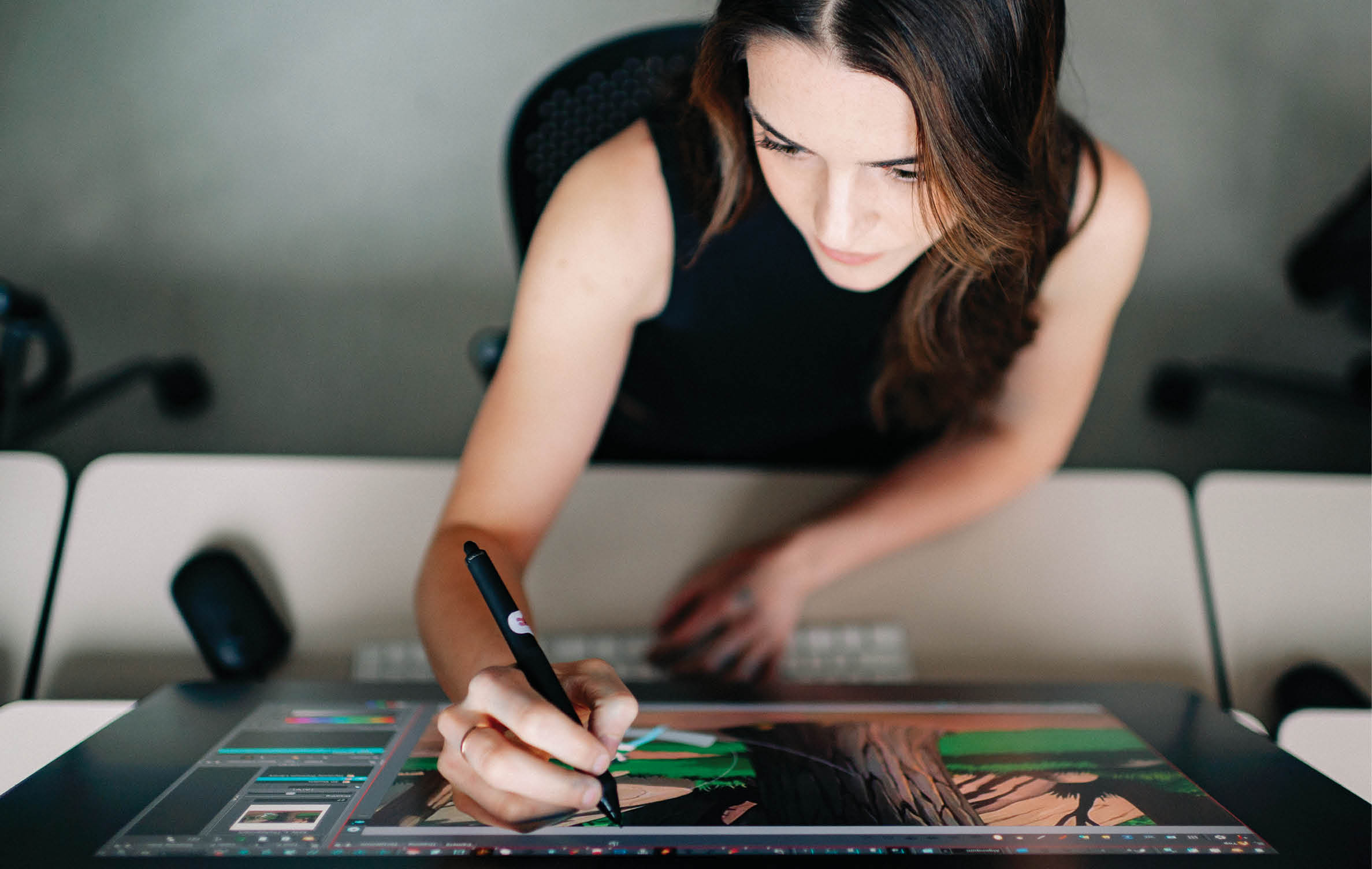 A woman is sitting at a desk using a laptop. AI generated content