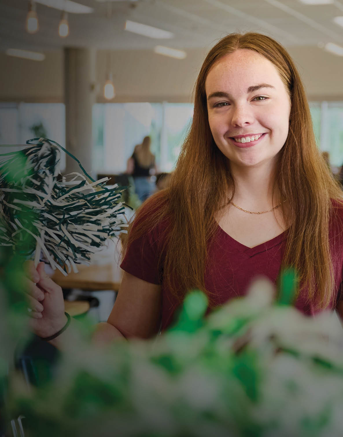 A woman is holding two green pom poms in her hands. AI generated content