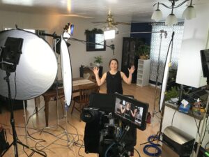 Crystal Martin-Lapenskie standing in the middle of a studio filming. 
