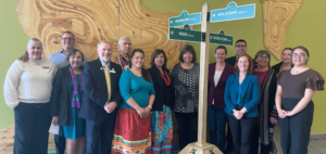 Large group of people standing around a street sign with the new Indigenous street names from the Ottawa Campus