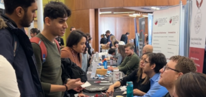 Students chat with employers sitting at tables in Nawapon at job fair