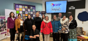 Group poses in the Mamidosewin Centre for the launch of the Soaring Circle sewing labs.