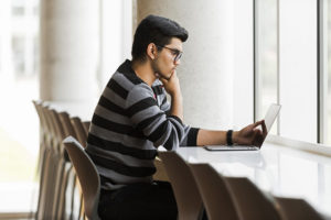 student working at a laptop