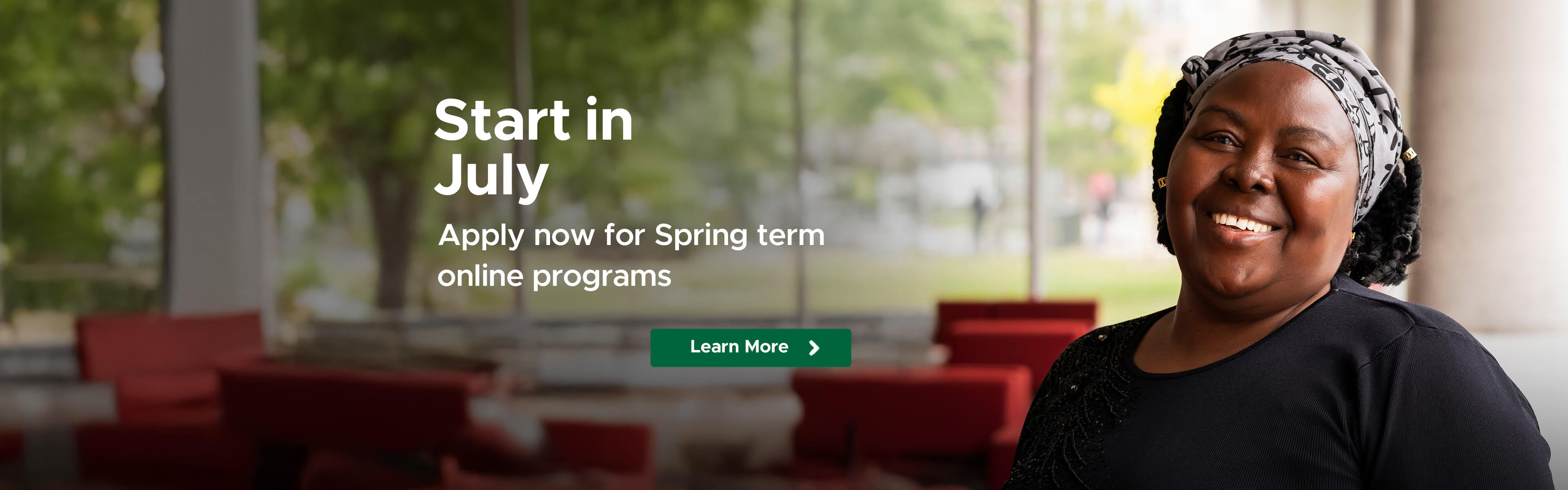 Adult smiling in a bright campus lounge with text “Start in July – Apply now for Spring term online programs”