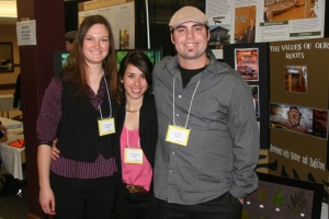 Two female and one male college student smiling at camera