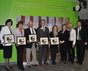 Capital Campaign members in front of donor wall