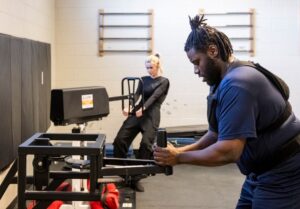 Students in the Police Foundations program using specific fitness equipment to prepare to apply for Police Services testing.