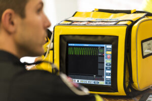 Advanced Care Paramedic Student working with ECG monitor