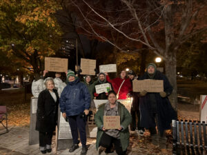 24 Hours of Homelessness event at Minto Park students and professors standing for a photo with cardboard signs.