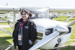 Student in front of small aircraft